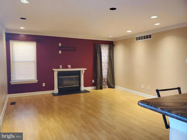 a view of empty room with a fireplace