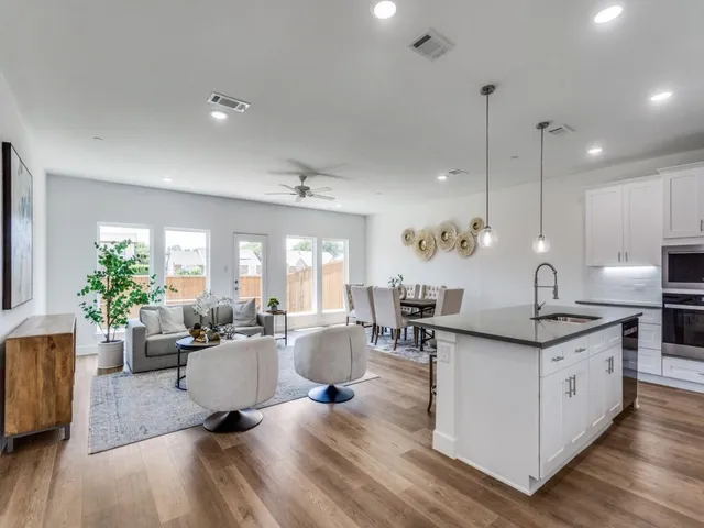a living room with furniture a potted plant and a fireplace