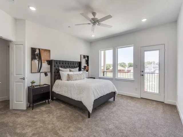 a spacious bedroom with a bed and window