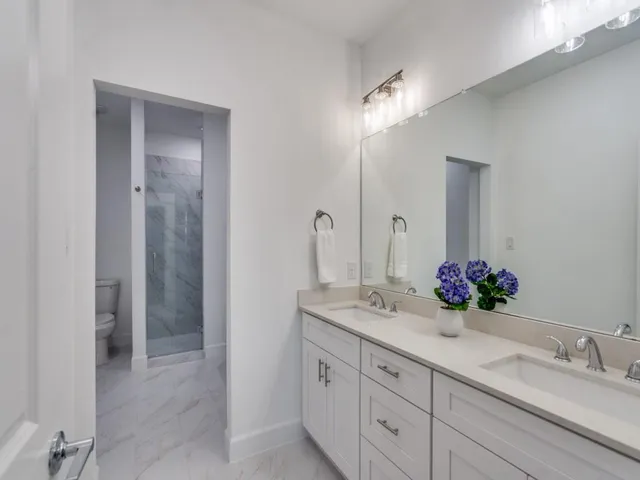 a bathroom with a double vanity sink and a mirror