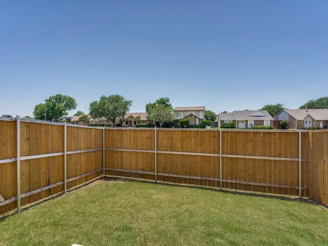 a view of a backyard with fence