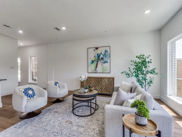 a living room with furniture and a potted plant