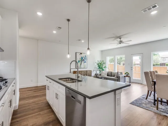 a kitchen with sink stove and refrigerator