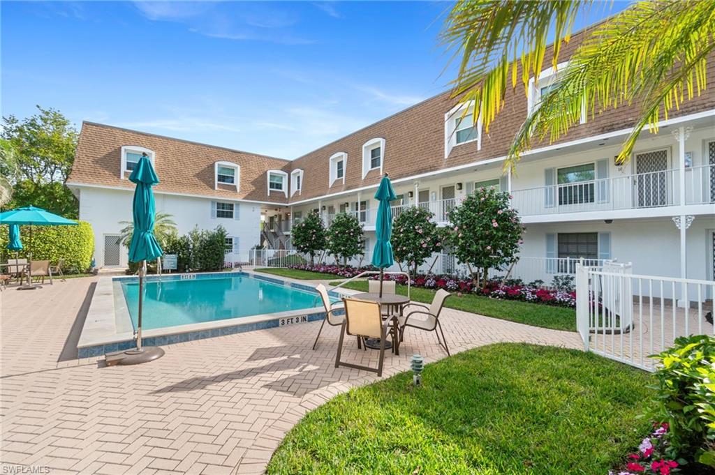 1222 Gordon Drive, Unit 2 Naples, FL 34102 - Photo 20 of 24 Community pool with a patio area