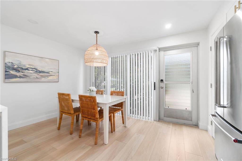 1222 Gordon Drive, Unit 2 Naples, FL 34102 - Photo 7 of 24 Dining space with light wood-style floors and baseboards