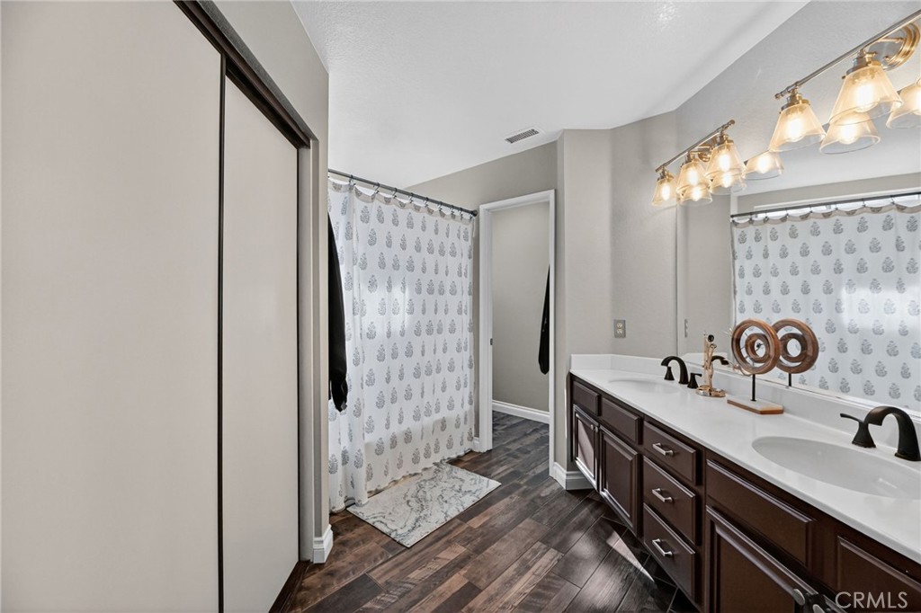 27536 Swallow Court Temecula, CA 92591 - Photo 21 of 55 a bathroom with a double vanity sink and a mirror