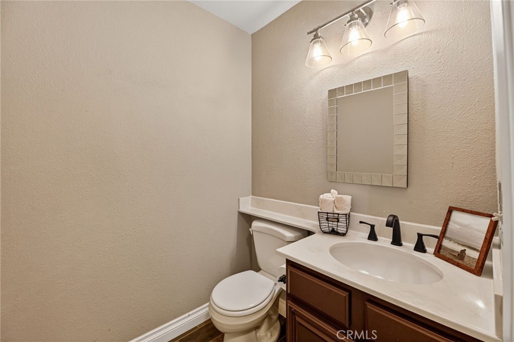 27536 Swallow Court Temecula, CA 92591 - Photo 22 of 55 a bathroom with a sink a toilet and mirror