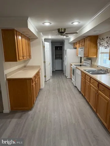 a large kitchen with stainless steel appliances kitchen island a large counter top and a wooden floors