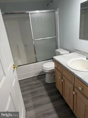 an empty room with a window and a chandelier fan