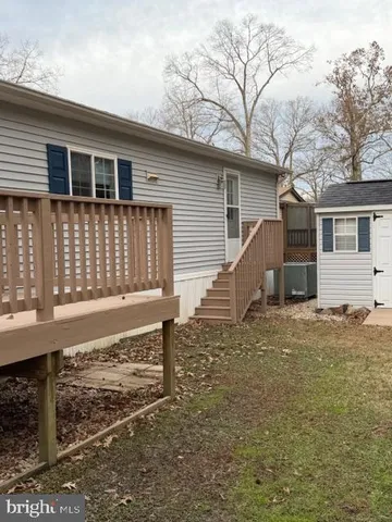 a view of a house with backyard and wooden fence