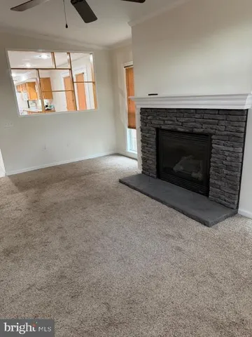an empty room with windows and fireplace