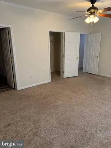 a view of an empty room and a bathroom