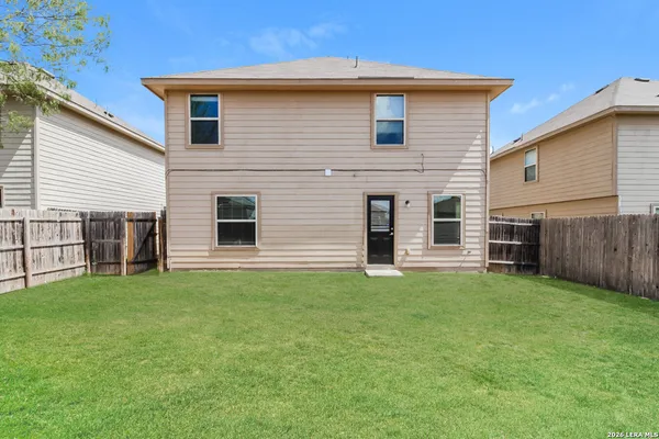 a view of a house with a backyard