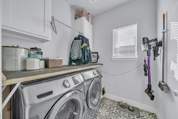 a bedroom with a bed and painting on the wall