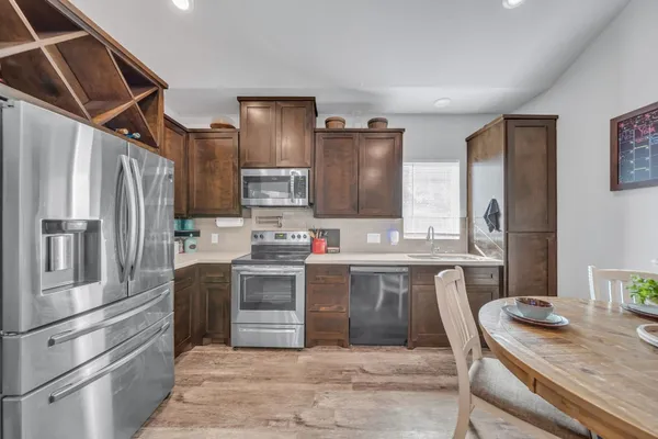 a bathroom with a sink a toilet a mirror and shower curtain