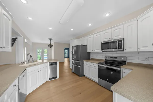 a view of a hallway with wooden floor