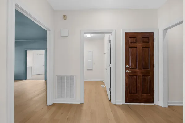 a view of a hallway with wooden floor