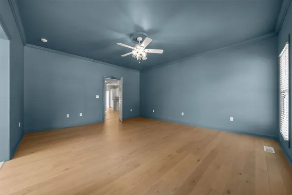 a view of an empty room and a window