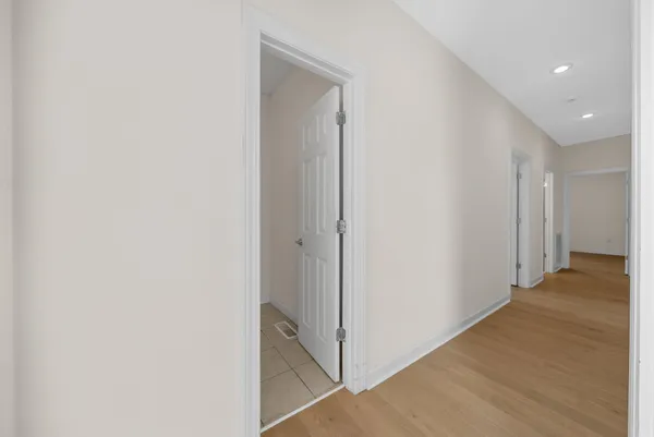 a view of staircase with wooden floor and white walls