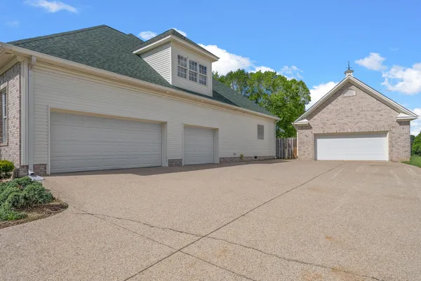 a view of a house with a yard and garage