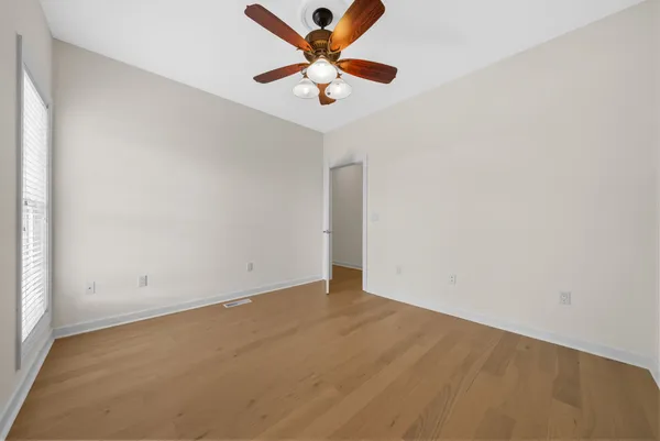 a view of a room with wooden floor