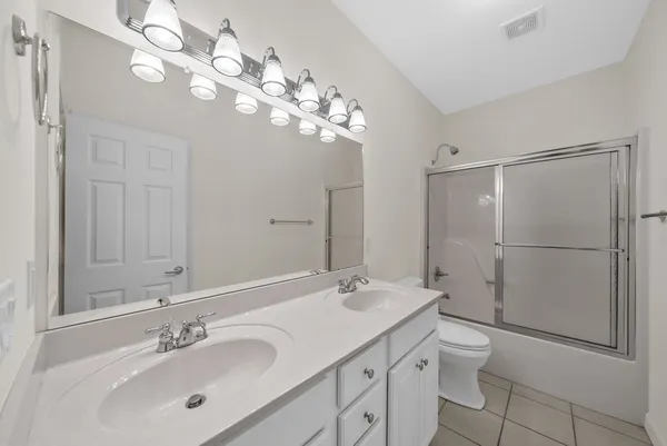 an aerial view of residential houses with outdoor space and street view