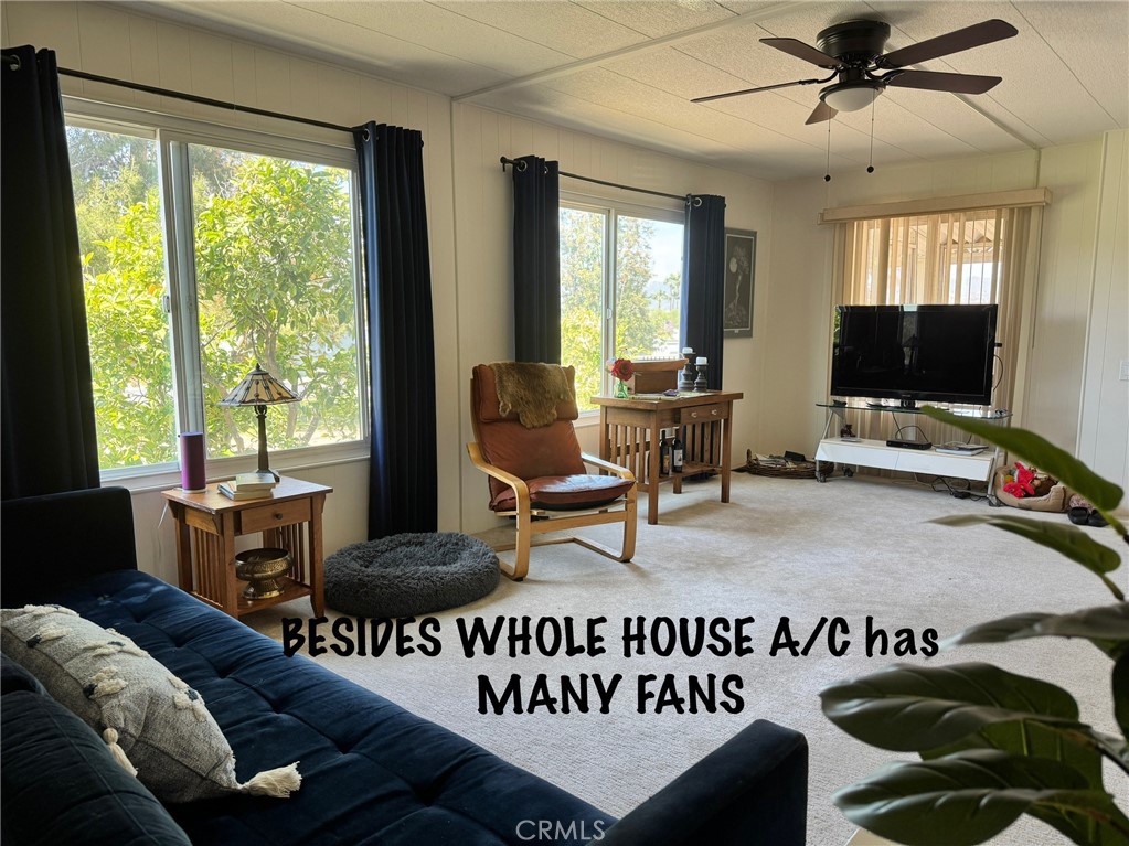 4650 Dulin Road, Unit 11 Fallbrook, CA 92003 - Photo 11 of 38 a living room with furniture and a flat screen tv
