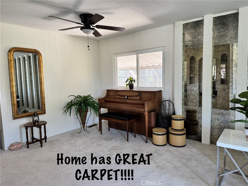 4650 Dulin Road, Unit 11 Fallbrook, CA 92003 - Photo 14 of 38 a living room with furniture a chandelier and a window