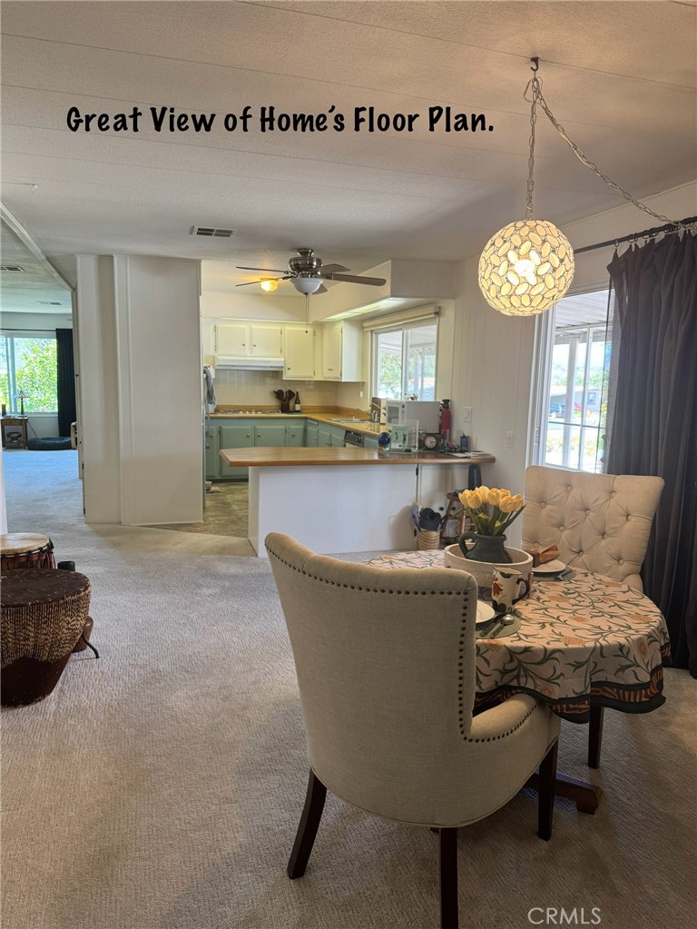 4650 Dulin Road, Unit 11 Fallbrook, CA 92003 - Photo 38 of 38 a living room with dining table and a chandelier