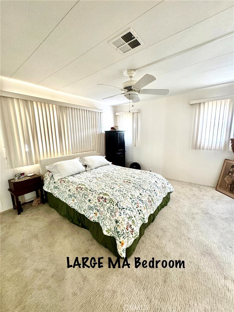 4650 Dulin Road, Unit 11 Fallbrook, CA 92003 - Photo 22 of 38 a bedroom with a bed and a couch