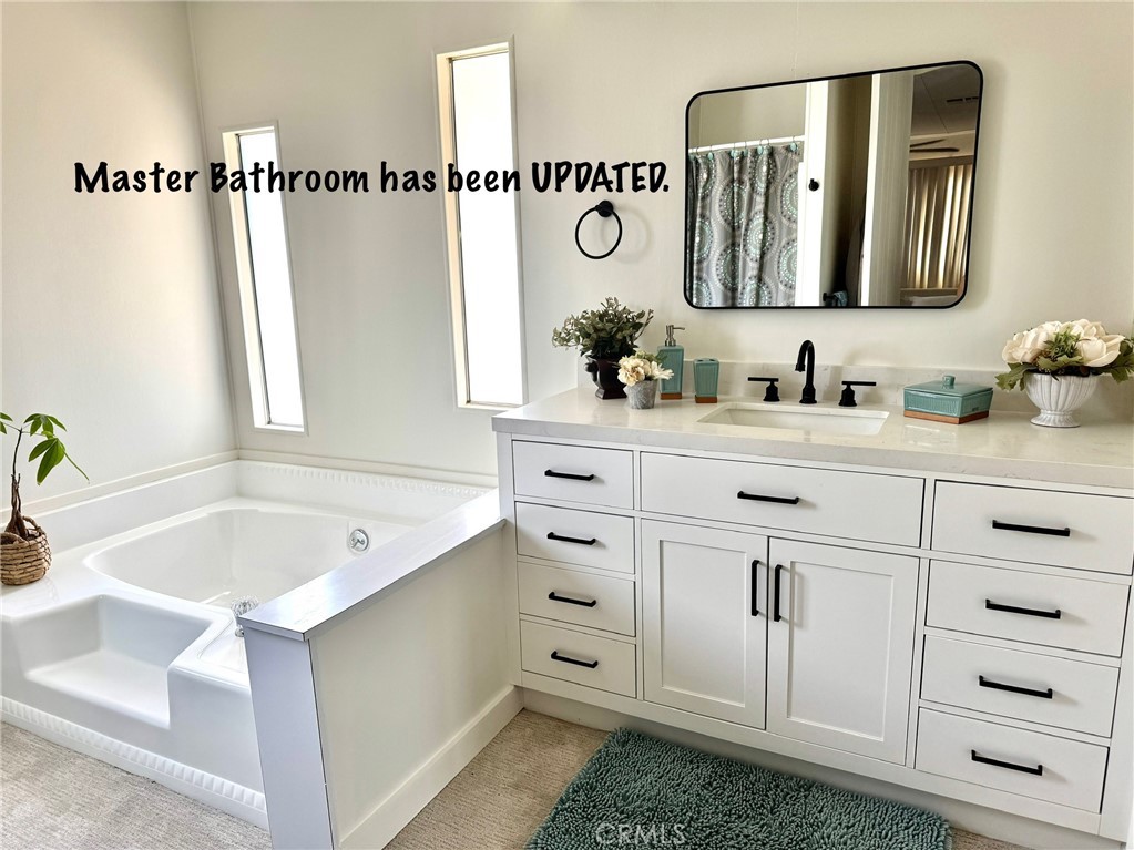 4650 Dulin Road, Unit 11 Fallbrook, CA 92003 - Photo 23 of 38 a bathroom with a tub sink and mirror