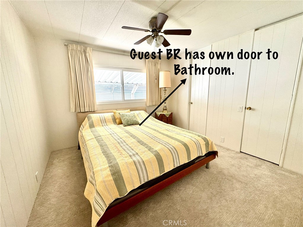 4650 Dulin Road, Unit 11 Fallbrook, CA 92003 - Photo 26 of 38 a bedroom with a bed and a chandelier