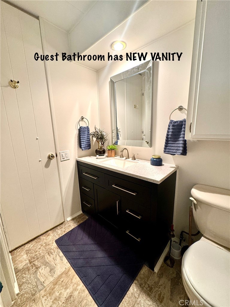 4650 Dulin Road, Unit 11 Fallbrook, CA 92003 - Photo 28 of 38 a bathroom with a sink mirror vanity and toilet