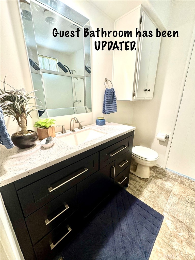 4650 Dulin Road, Unit 11 Fallbrook, CA 92003 - Photo 29 of 38 a bathroom with a sink a toilet and mirror