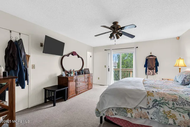 a bed room with a bed a dresser and mirror