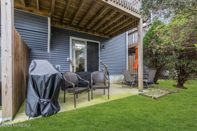 a backyard of a house with table and chairs