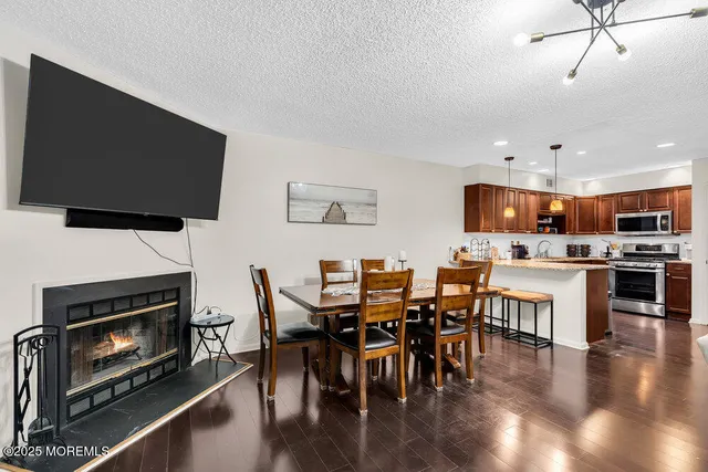 a kitchen with stainless steel appliances granite countertop a sink refrigerator and microwave