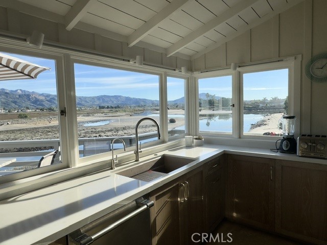 539 Sand Point Road Carpinteria, CA 93013 - Photo 15 of 26 a kitchen with a sink and large windows