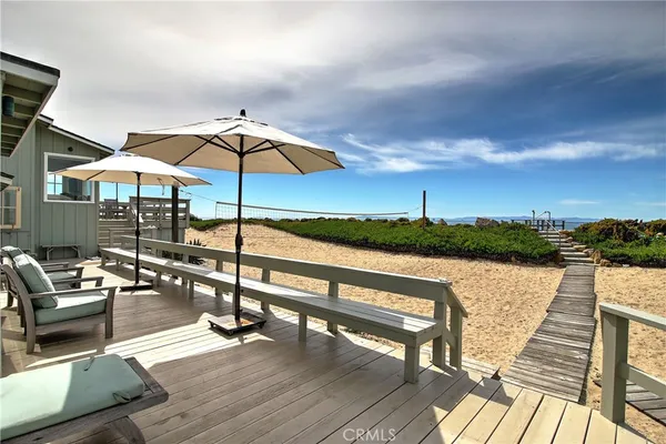 a view of sitting area with furniture and umbrella