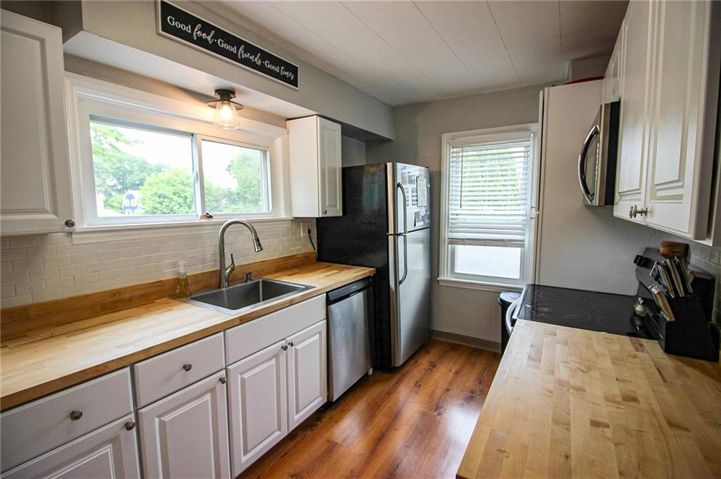 684 Elizabeth Street Bridgeville, PA 15017 - Photo 11 of 34 a kitchen with a sink stove and refrigerator