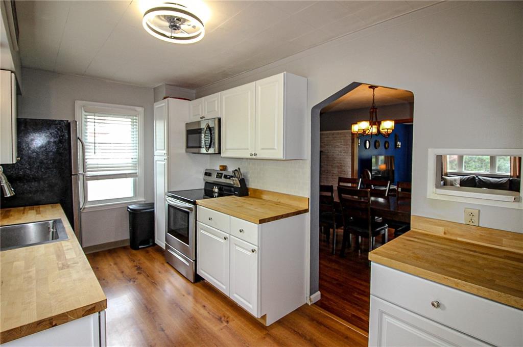 684 Elizabeth Street Bridgeville, PA 15017 - Photo 13 of 34 a kitchen with a stove a refrigerator and a sink