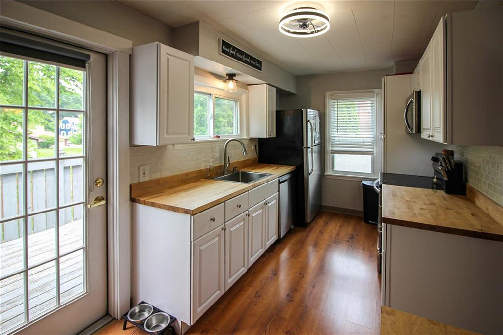 684 Elizabeth Street Bridgeville, PA 15017 - Photo 14 of 34 a kitchen with a stove sink and a refrigerator