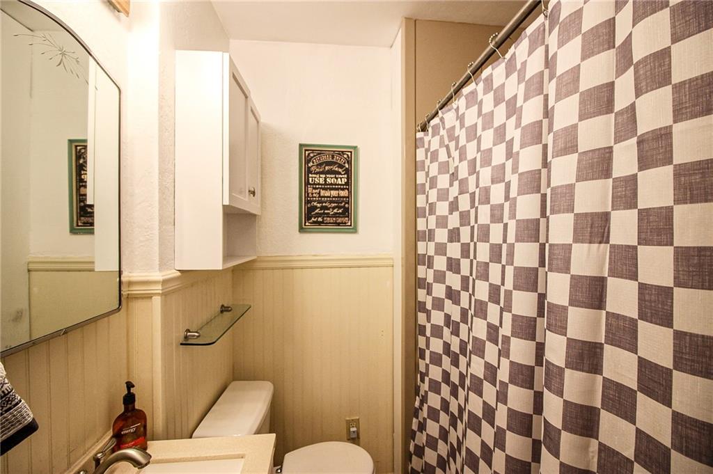 684 Elizabeth Street Bridgeville, PA 15017 - Photo 16 of 34 a bathroom with a toilet and a shower curtain