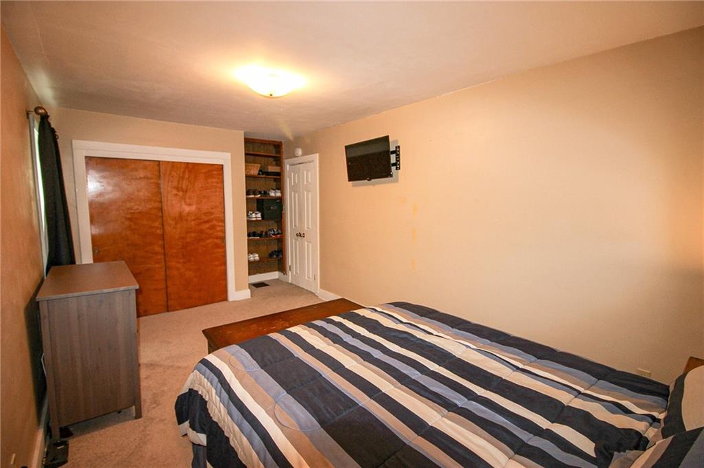 684 Elizabeth Street Bridgeville, PA 15017 - Photo 20 of 34 a bedroom with a bed and a flat tv screen