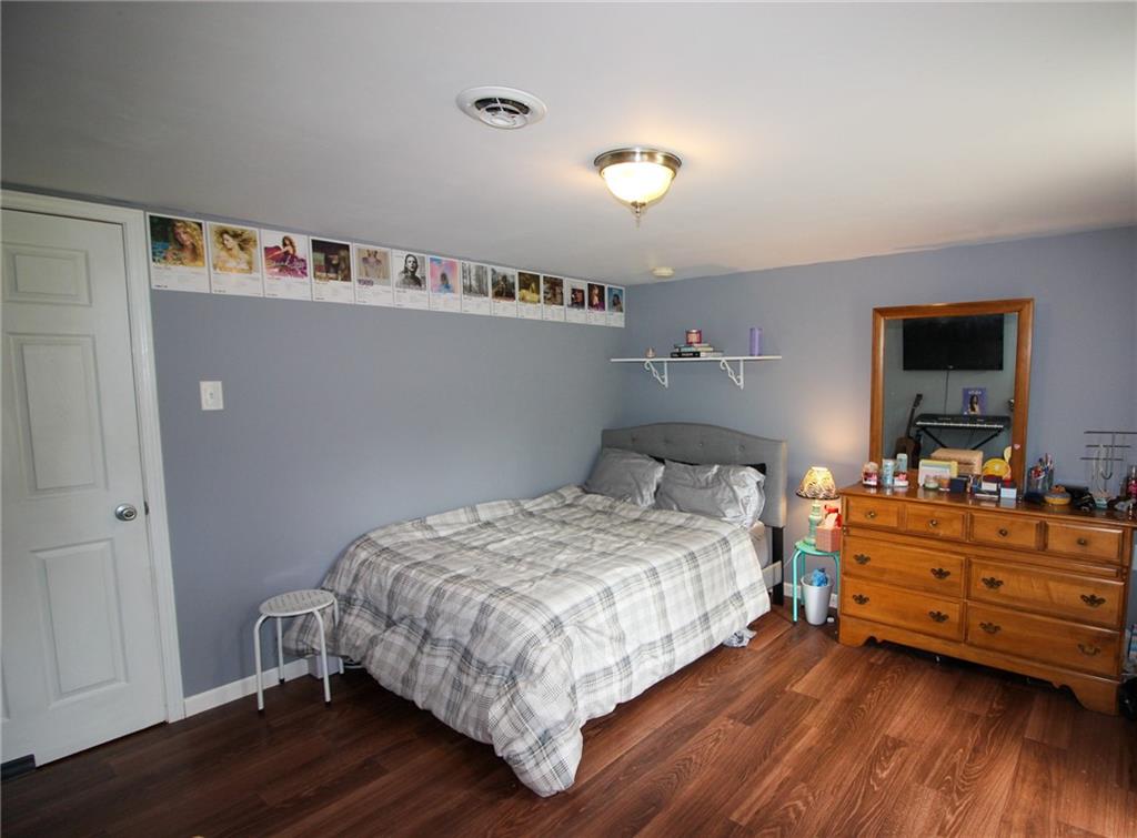 684 Elizabeth Street Bridgeville, PA 15017 - Photo 28 of 34 a bedroom with bed and wooden floor