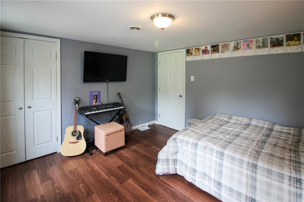 684 Elizabeth Street Bridgeville, PA 15017 - Photo 29 of 34 a bedroom with a bed and a flat screen tv
