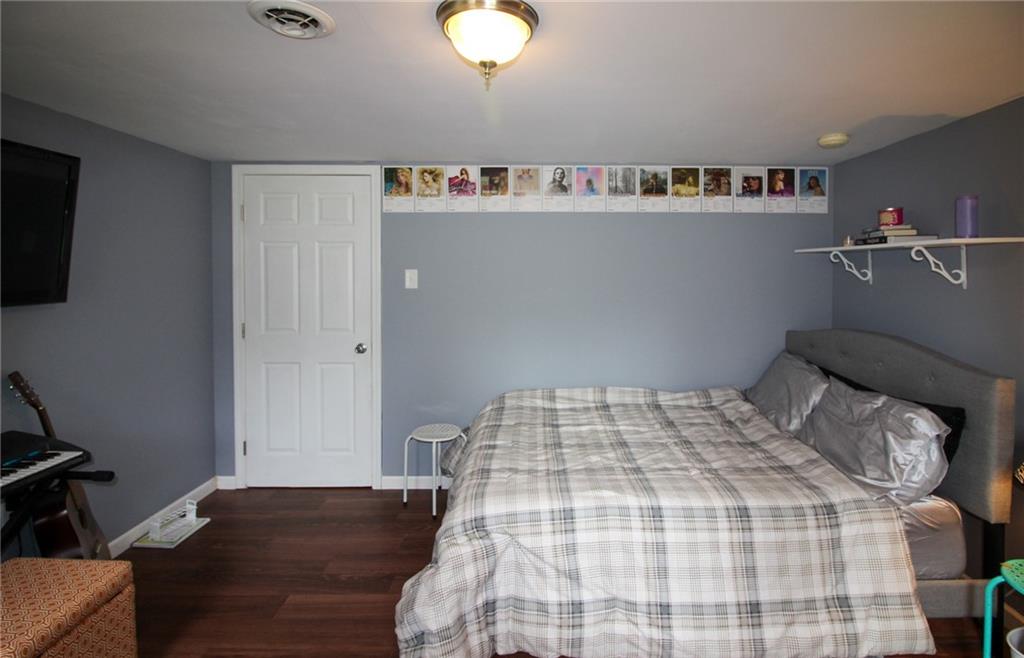 684 Elizabeth Street Bridgeville, PA 15017 - Photo 30 of 34 a bedroom with a bed and wooden floor