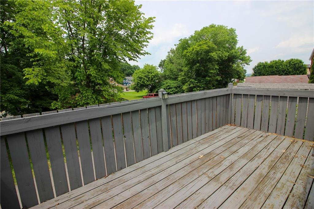 684 Elizabeth Street Bridgeville, PA 15017 - Photo 31 of 34 a balcony with wooden floor and trees in the back