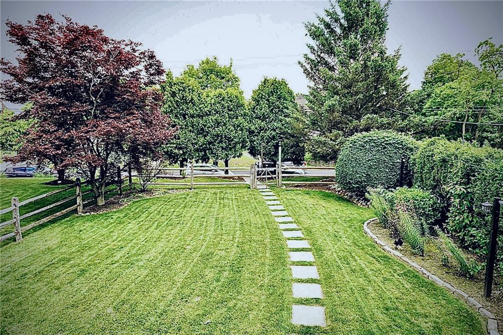 684 Elizabeth Street Bridgeville, PA 15017 - Photo 32 of 34 a view of a garden with lawn chairs