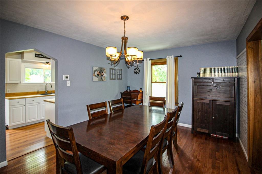 684 Elizabeth Street Bridgeville, PA 15017 - Photo 10 of 34 a dining room with furniture a chandelier and wooden floor